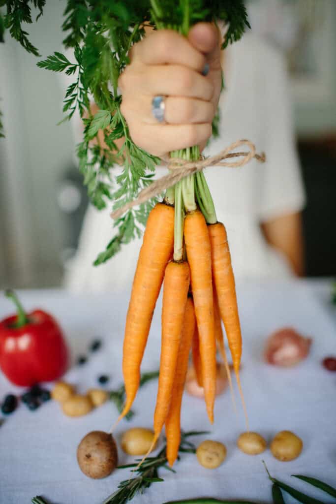 hand holding bunch of carrots