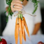 hand holding bunch of carrots