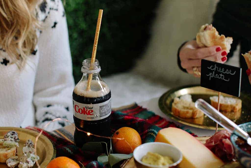 close up scene of a table hosting friends with food