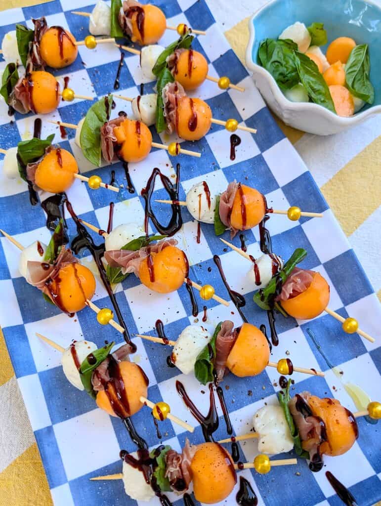 Melon and Prosciutto Skewers with mozzarella on a platter