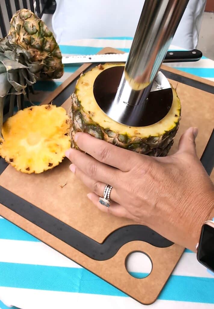 Using pineapple corer to slice pineapple step 1