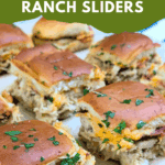 cheesy chicken bacon ranch sliders on a platter, soft bread with melted cheese and herbs