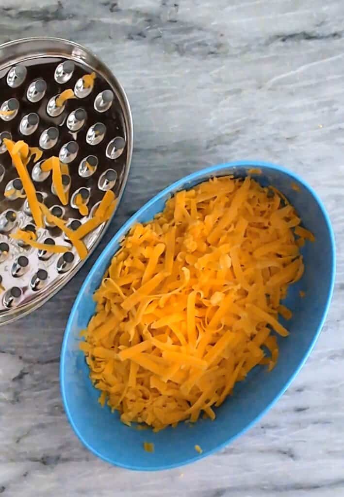 Cheddar Bacon Ranch Football Cheese Ball shredded cheese