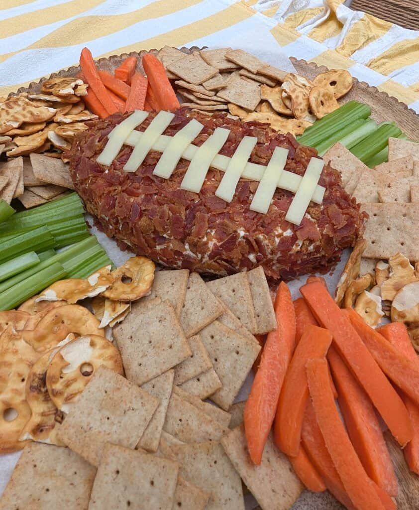 wider shot of Cheddar Bacon Ranch Football Cheese Ball