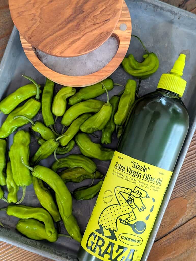 shishito peppers, salt, olive oil on a tray