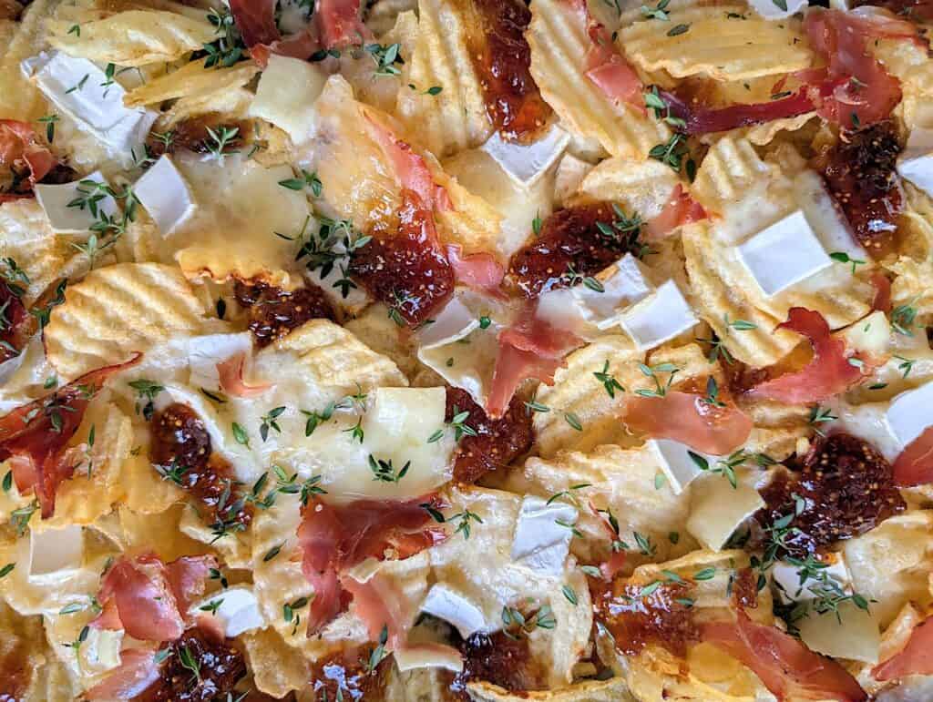 detailed close up shot of final baked Potato Chip Charcuterie Board Nachos {Brie & Fig Jam}