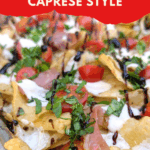 crispy nachos with cherry tomatoes, fresh herbs, sour cream, and balsamic glaze