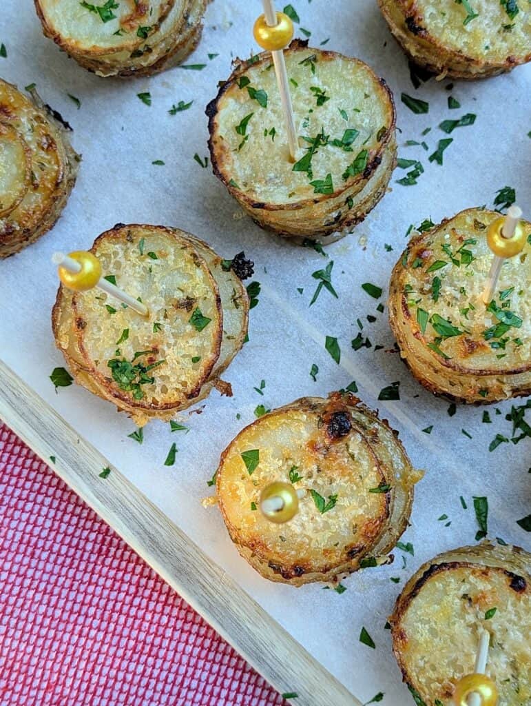overhead shot of garlic & parmesan crispy potato stacks in muffin tins