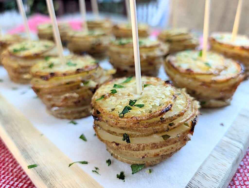 closeup horizontal shot of garlic & parmesan crispy potato stacks in muffin tins