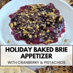 A whole baked brie cheese topped with ruby red cranberry sauce and crunchy chopped pistachios, presented in a white serving dish with various crackers around the edges. Text overlay: HOLIDAY BAKED BRIE APPETIZER WITH CRANBERRY & PISTACHIOS.