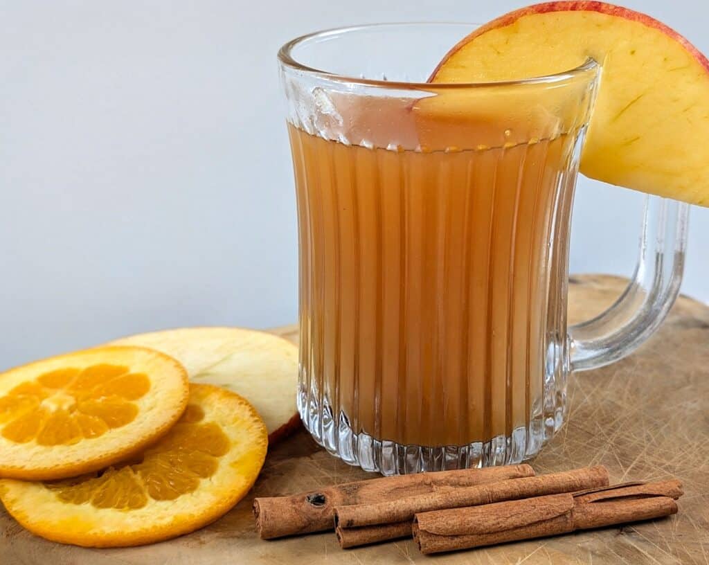 Spiked Fireball Apple Cider on board with garnishes
