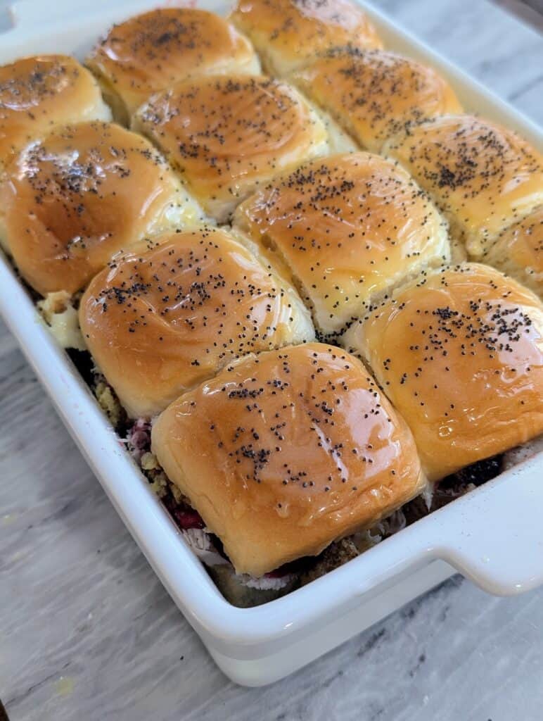 turkey cranberry sliders sprinkled with poppy seed ready for baking