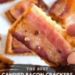 Extreme close-up of a hand holding a single maple candied bacon cracker, highlighting the texture and sweet glaze with a hint of red pepper flakes. The text overlay reads: "THE BEST CANDIED BACON CRACKERS {with maple syrup}."