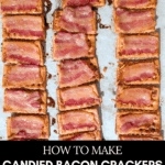 Overhead shot of many assembled candied bacon crackers arranged in columns on a baking sheet lined with parchment paper, fresh out of the oven. The bacon is caramelized and slightly crispy. The text overlay reads: "HOW TO MAKE CANDIED BACON CRACKERS WITH MAPLE SYRUP."