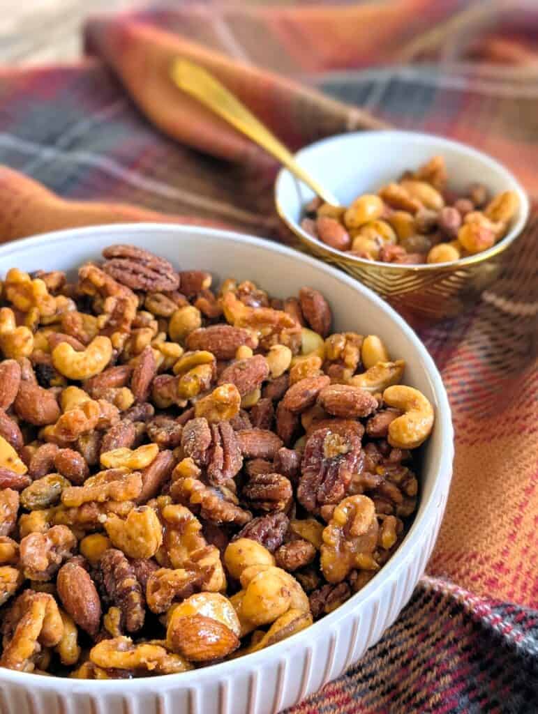 Candied Sweet and Spicy Nuts with large and small bowl filled with nuts