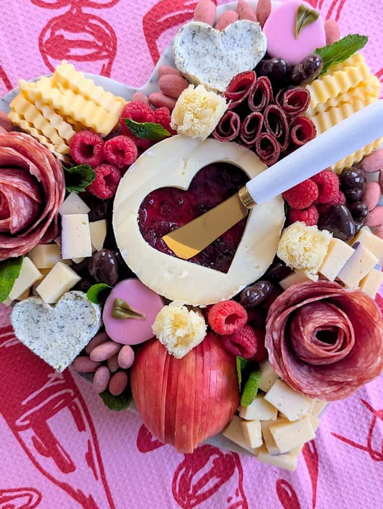 overhead shot of the Valentine&rsquo;s Charcuterie Board with spreading knife