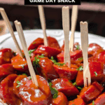 BBQ smoked sausage bites coated in sauce and served with toothpicks for easy game day snacking.