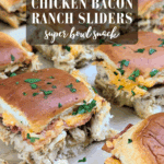 Chicken bacon ranch sliders made with shredded chicken and melted cheese on soft rolls, garnished with parsley.