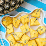 Fireball-infused pineapple bites served on a platter with cocktail picks for an easy Super Bowl snack.