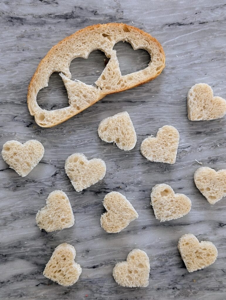 sourdough bread with heart shapes cut out of the slice