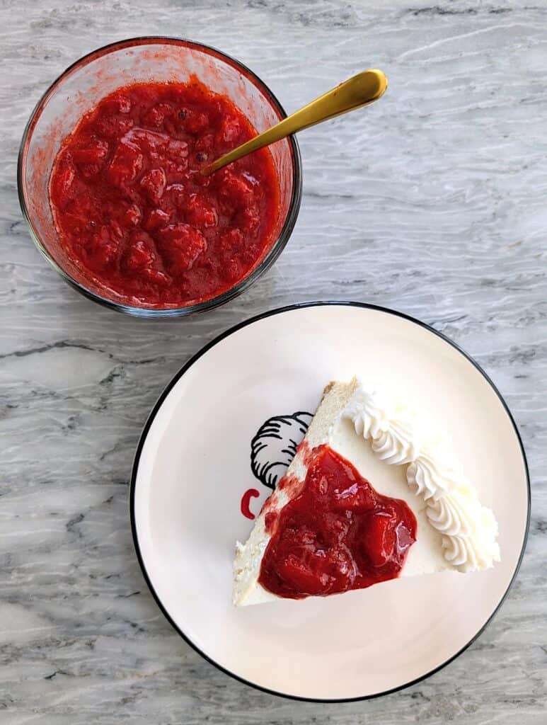 The Best Homemade Strawberry Topping for Cheesecake with a slice of cake and bowl of sauce