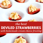 Strawberry halves filled with cream cheese frosting and topped with graham cracker crumbs on a white serving tray.
