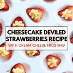Close-up of deviled strawberries with cream cheese frosting and graham cracker crumbs on a white tray.