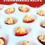 Close-up of deviled strawberries filled with cream cheese frosting and topped with graham cracker crumbs on a white serving tray.