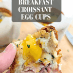 Pinterest pin with text “(eggs Napoleon) Breakfast Croissant Egg Cups” showing a close-up of a croissant egg cup with ham, egg, and flaky croissant layers.